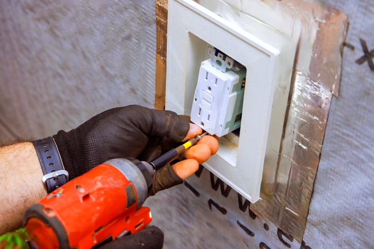 Electrician installing electrical outlet