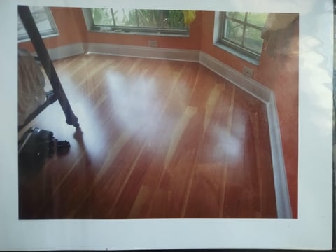 Hardwood floor being polished with equipment