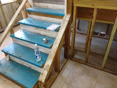 Blue painted wooden staircase with weathered white railings