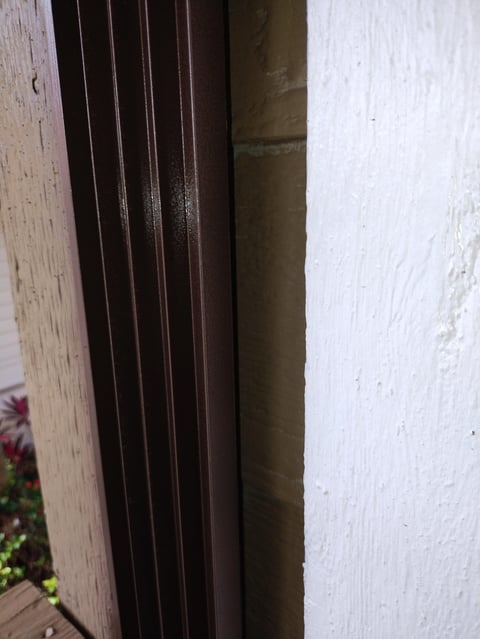 Dark wooden door frame against white wall