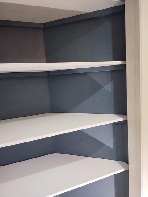 Built-in shelving with dark blue back panels